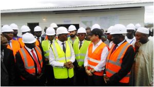 Minister Mama Fouda chatting with construction workers at the site