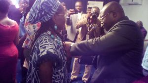 Governor Ivaha Diboua attaching medals on laureates 