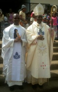 Rev. Fr. Jacob Ketchen poses with Bishop Nkea after ordination