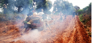 Boy drag car through the mud of Ndian roads