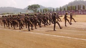 Graduating soldier march pass in front of defense minister and family members