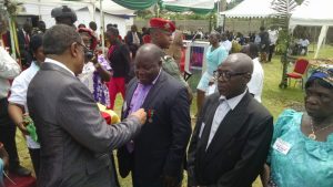 Minister of Labour and Social Security, Gregoire Owona decorating CDC worker with labour medal of honour