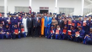 AIMS Graduates pose with officials after convocation ceremony