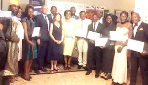 13 Chevening Scholars pose with H.E Rawan Laxton 