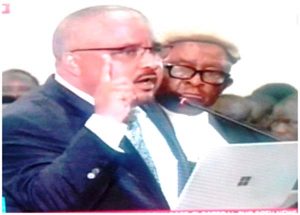 Candidate Joshua Osih addressing Constitutional Council President, 