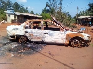 Skeleton of a burnt car abandoned in the road in Bafut