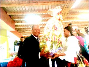 SONARA General Manager, SIMO NJONOU receives bouquet of flower from  staff during New Year wishes ceremony