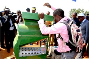 Nyuo John Chia displays his newly invented cocoa pod breaking machine to the public in the presence of North west governor, Adolf Lele L’Afrique