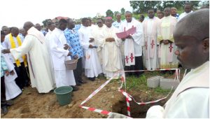  Bishop Agapitus Nfon cuts the ribbon, laying the foundation  stone for the CMA National Secretariat