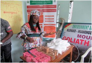 Director of CAWI, Nkembi Lucia addressing participants after the making of medicated soap, powdered soap and washing soap