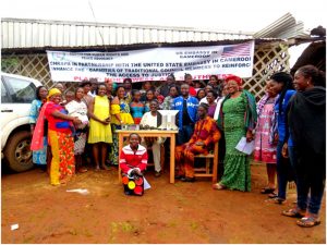 Mbelem community members pose with  CHRAPA officials in front of Paralegal Center 