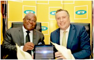 Minister Joseph Le and MTN Cameroon CEO, Hendrik Kasteel brandish digital signed deal