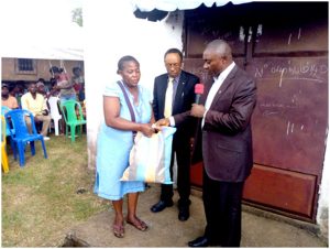 Gwanfogbe Maurice, Founder/ CEO of Phride International, hands gift to IDPs